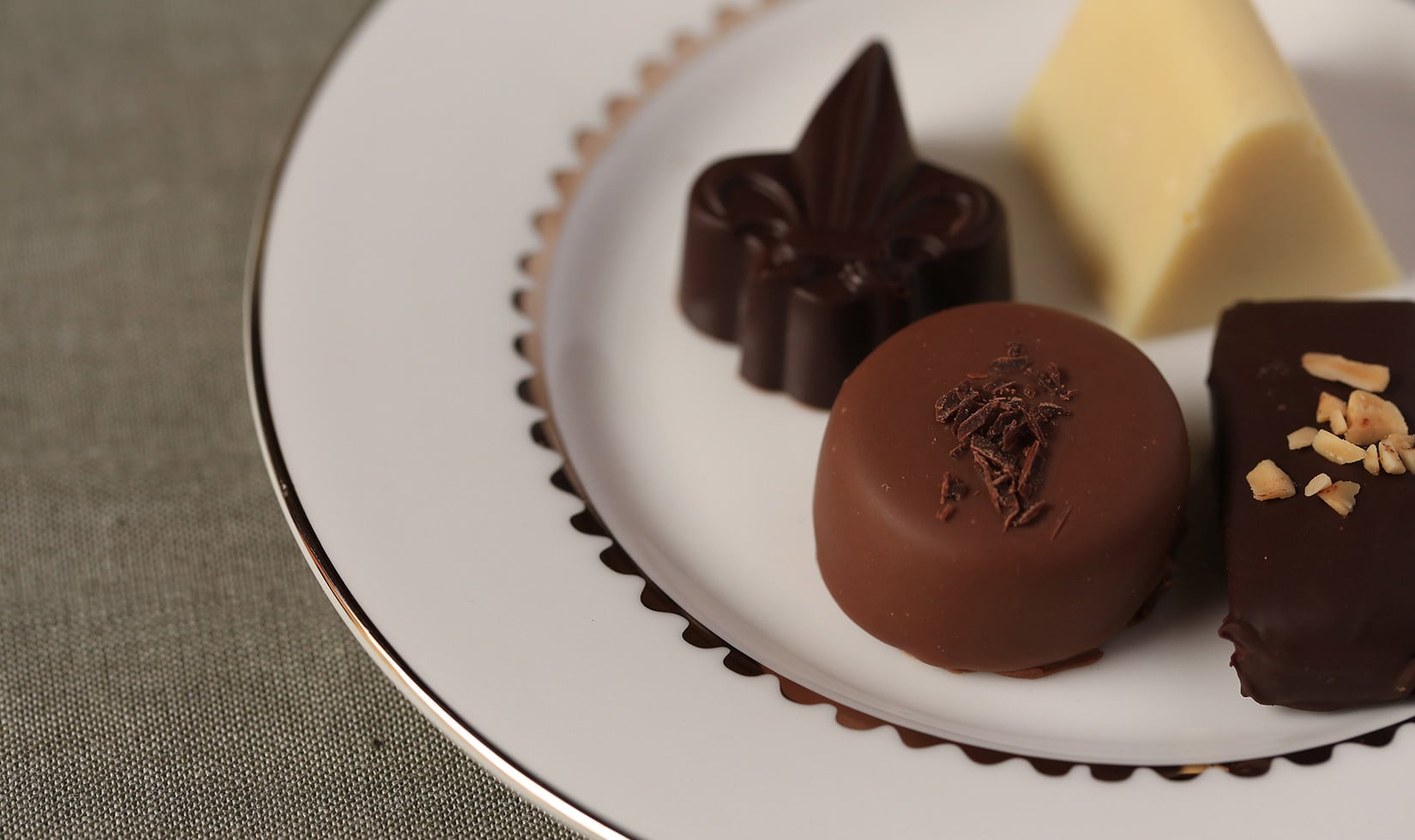 close up of four Jordan Winery chocolate truffles presented on small plate