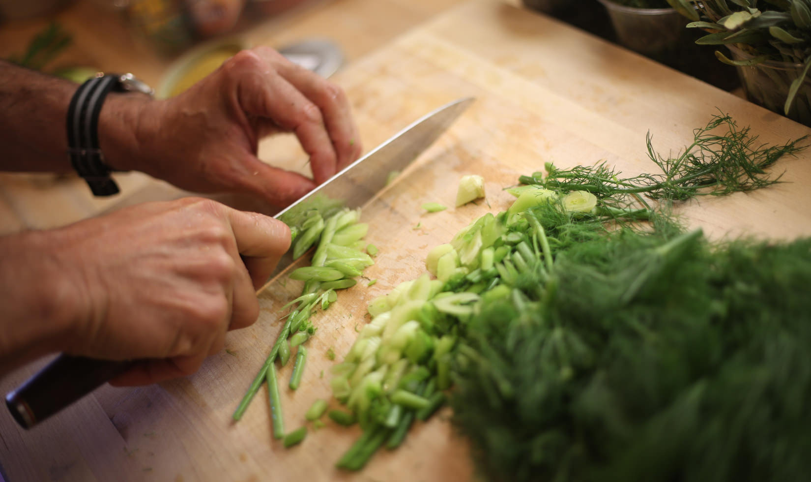 Herb Roasted Pork Belly Porchetta Recipe a man preparing the herbs for porchetta recipe