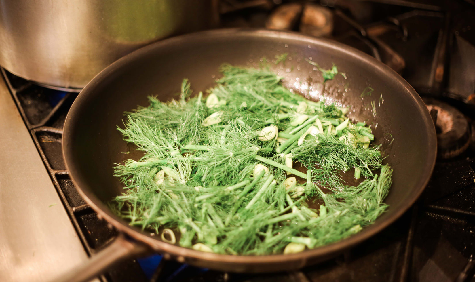 Herb Roasted Pork Belly Porchetta Recipe stir frying the herbs