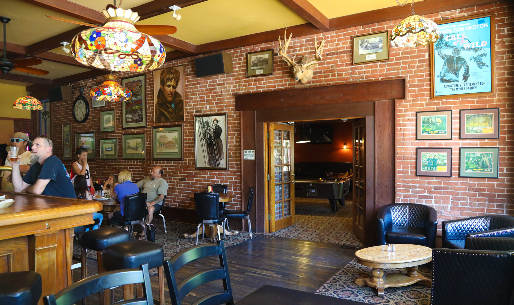People drinking inside the Lodge bar area in Sonoma Valley with lot of arts in the wall