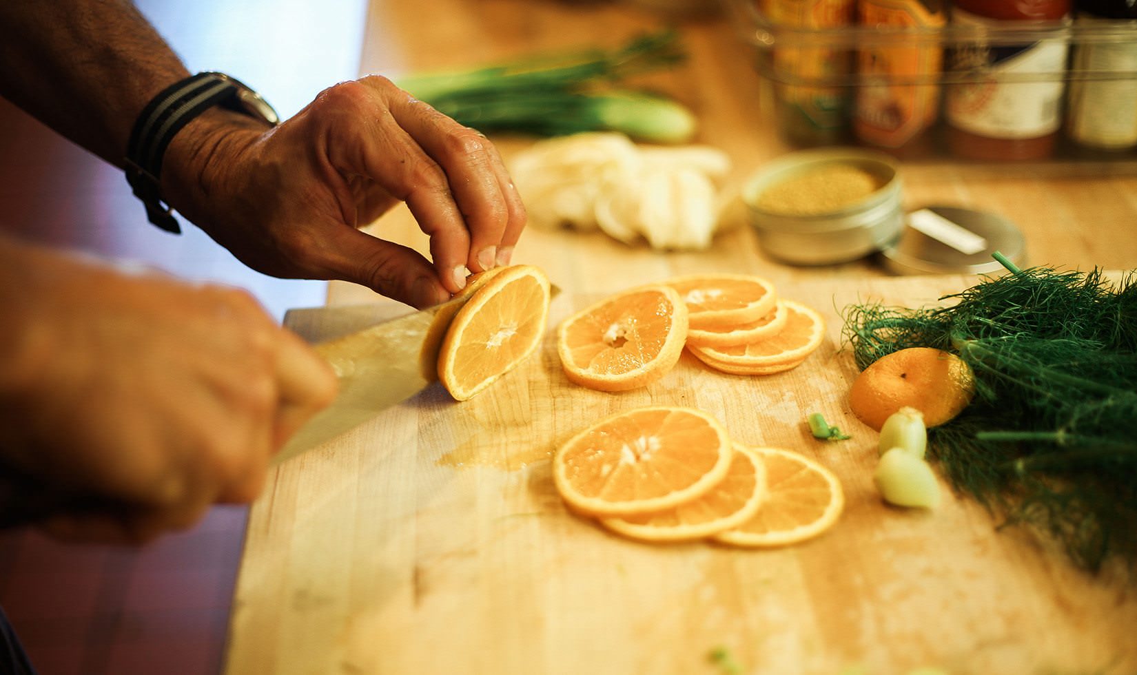 Herb Roasted Pork Belly Porchetta Recipe a man preparing the orange to be mix for the recipe for art