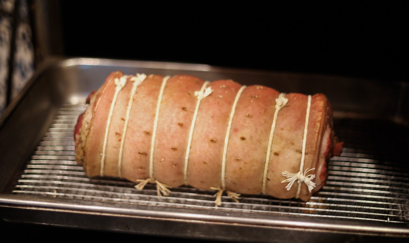 closing both ends for pork belly ready to be roasted roasting the pork belly