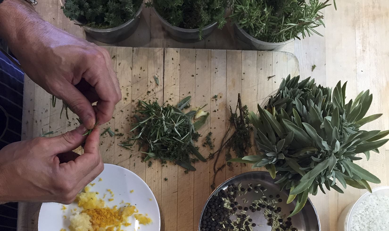 Herb Roasted Pork Belly Porchetta Recipe chef preparing the spices and herbs for pork belly porchetta recipe as featured in wine country table