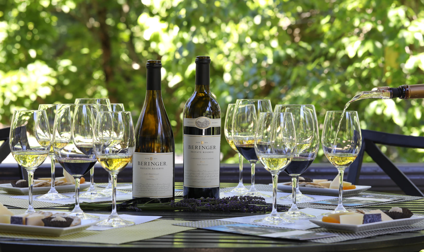 2 bottles of white wines with wine glasses in the table