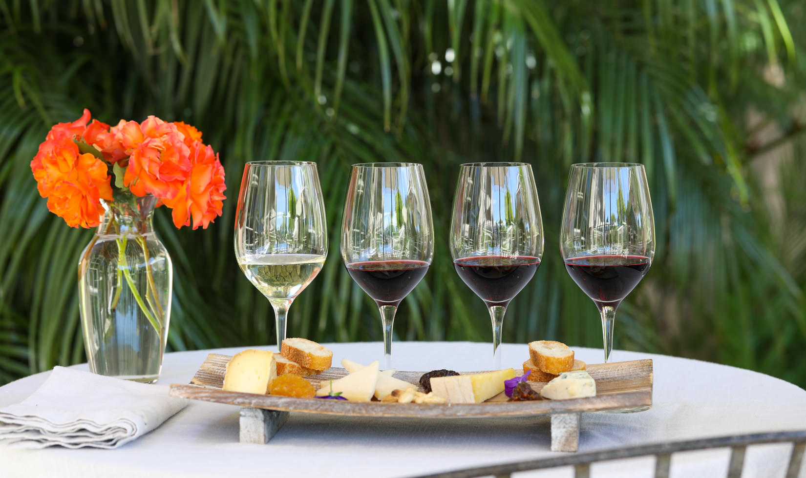 Napa Wine and Cheese Tasting WIneries 4 wine glasses with wine and cheese varieties in the table
