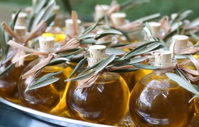 Jordan Winery extra virgin olive oil in glass bottles with olive leaf sprig garnish