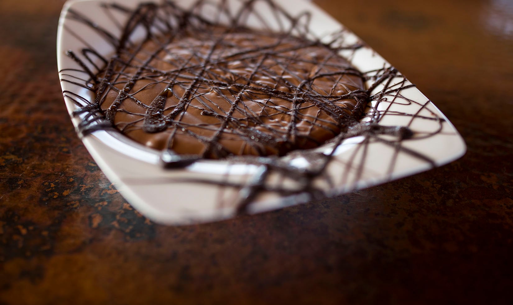 close up of Jordan Winery Easy Chocolate Mousse with dark chocolate drizzle