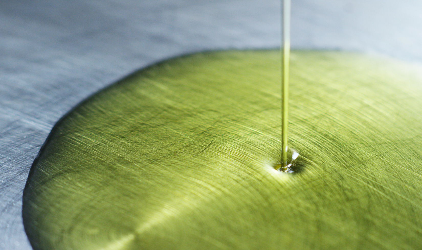 Olive Oil Health Benefits olive oil making process, olive oul poured in a pan