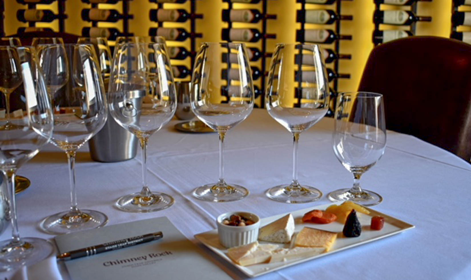 Napa Wine and Cheese Tasting WIneries 6 wine glasses with delicious varieties of cheese in a table with menu list
