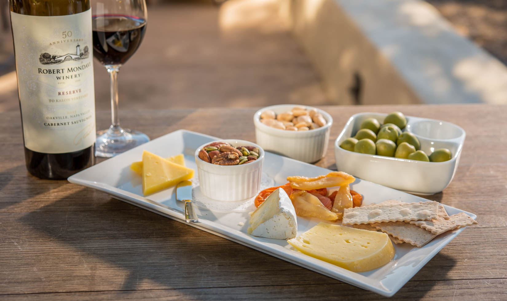 Napa Wine and Cheese Tasting WIneries wine and cheese in the table with nuts and grapes