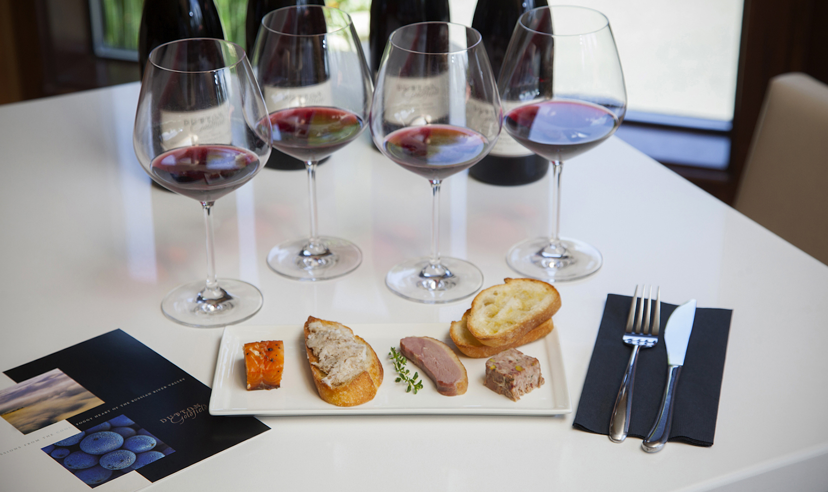 4 wine glasses with spoon and fork and a delicious delicacy 