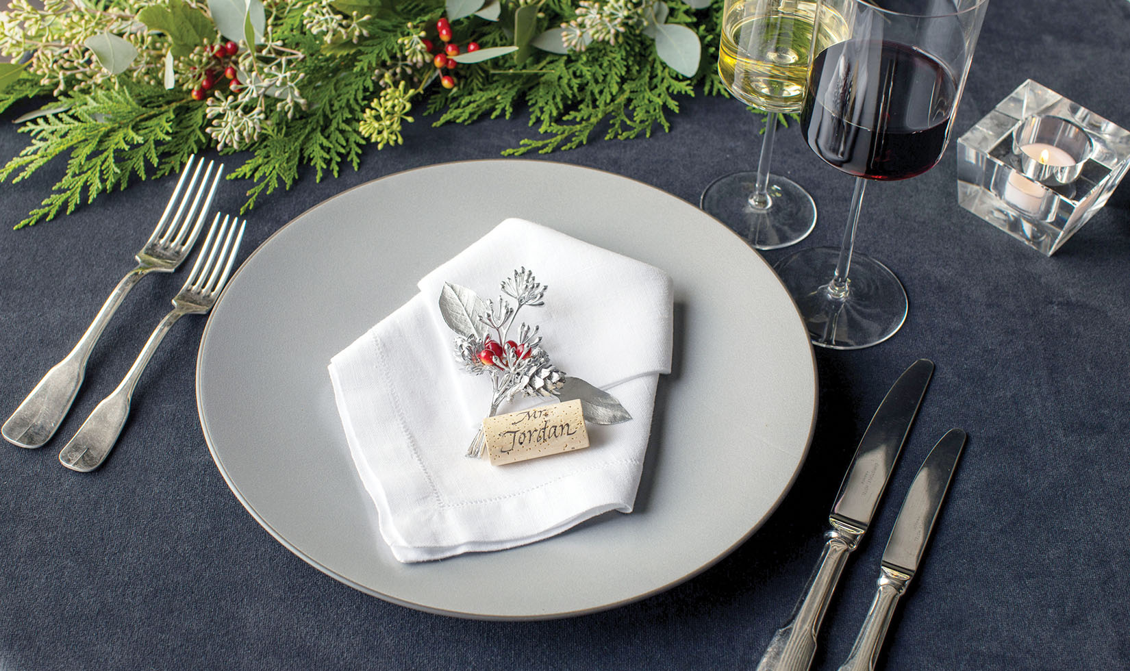 Elegant Christmas Table Setting Ideas Silver Seeded Eucalyptus place setting on white napkin
