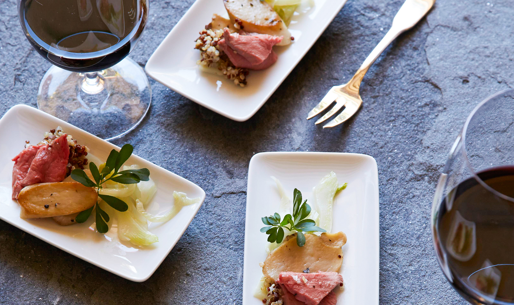 Wine and Appetizer Pairing Guide lamb with quinoa and mushrooms on small plates with wine glasses