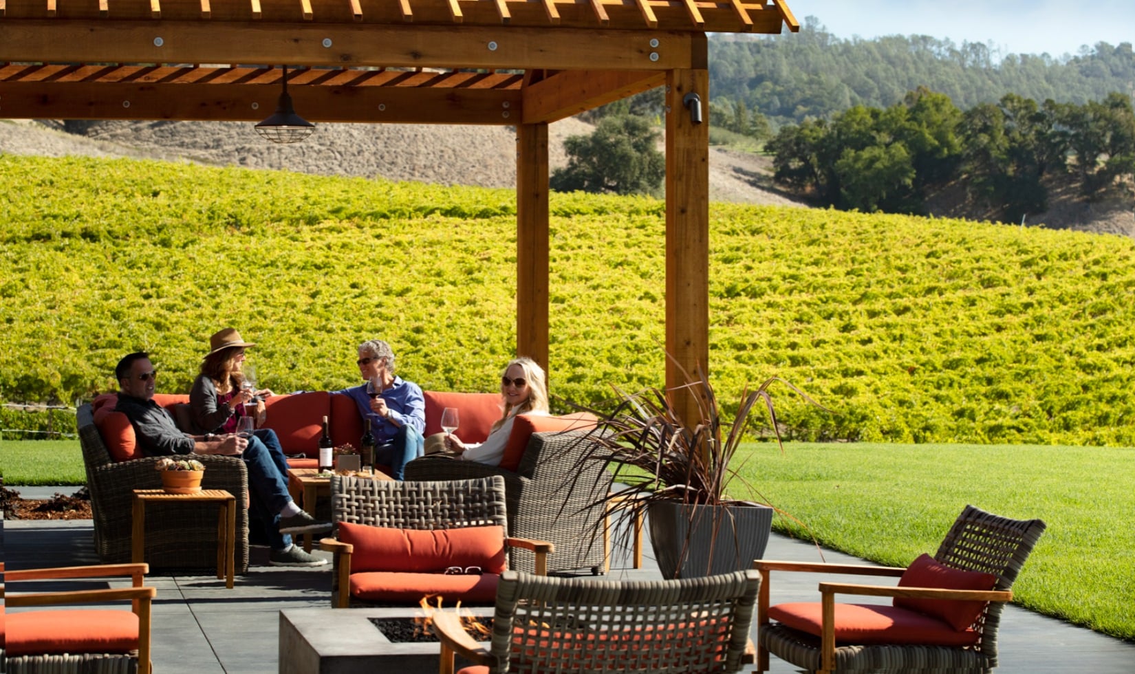 Wineries with a View in Healdsburg, Sonoma County Group on winery terrace on outdoor couches wine tasting