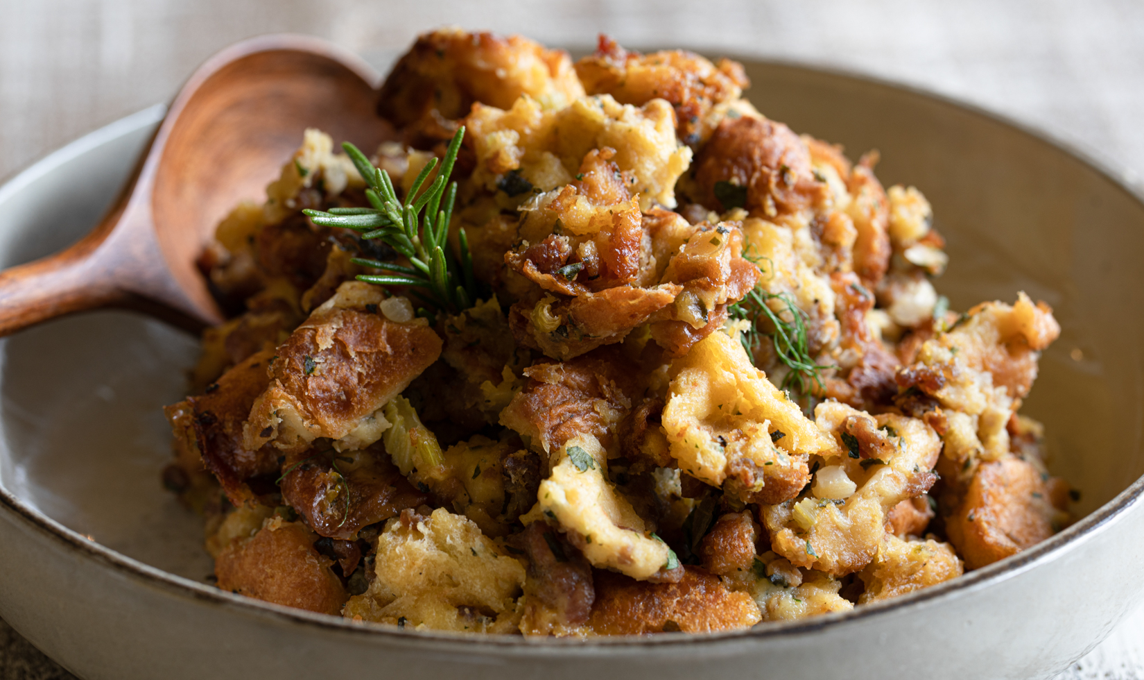 Thanksgiving Dinner Ideas thanksgiving mushroom pancetta stuffing recipe in a bowl with wooden spoon