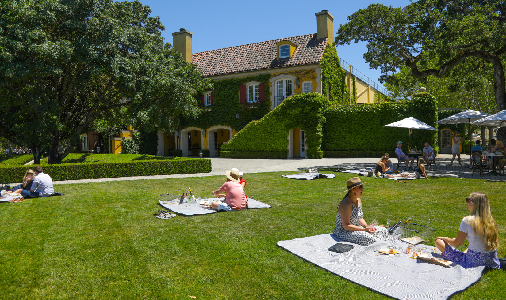 Picnic goers lounge in front of Jordan Chateau.