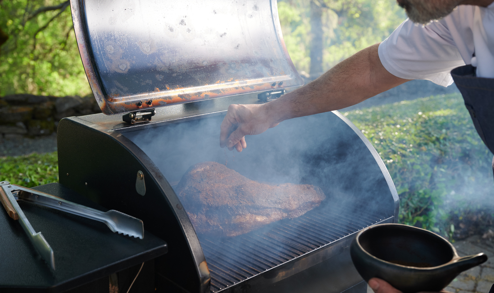 Wine Pairing with BBQ person adding salt in the grilled meat in the griller