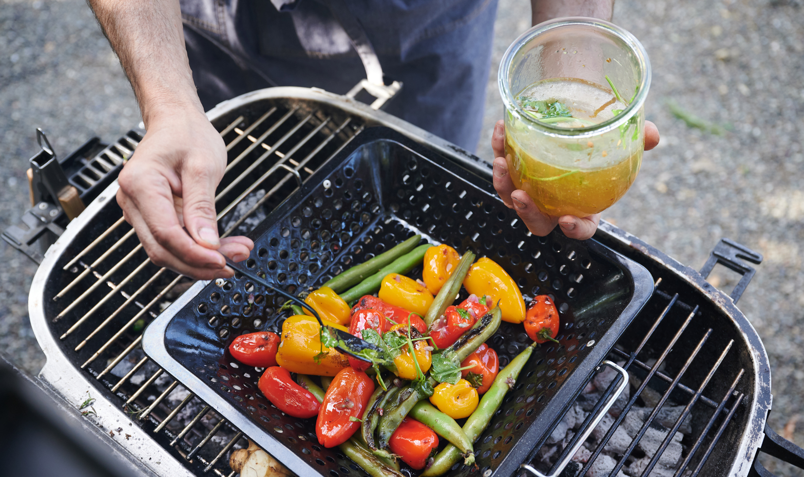 Types of Grills and Smokers a chef putting sauce in the spices and grilling it