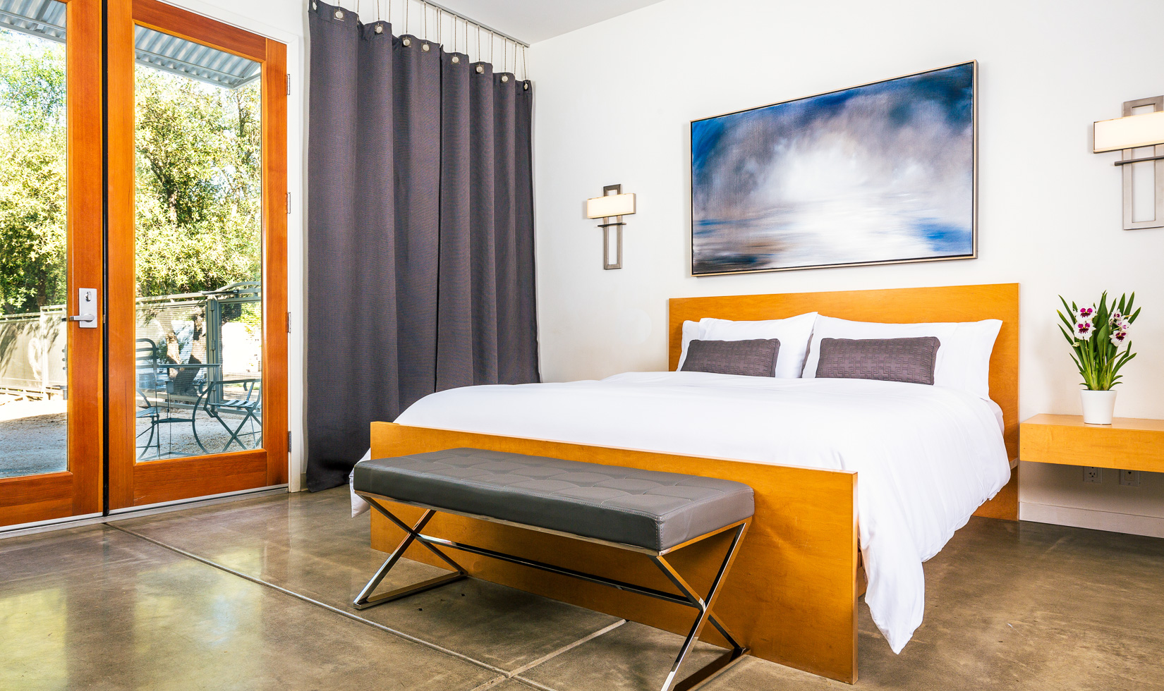 Modern bedroom with wooden accents and natural light.