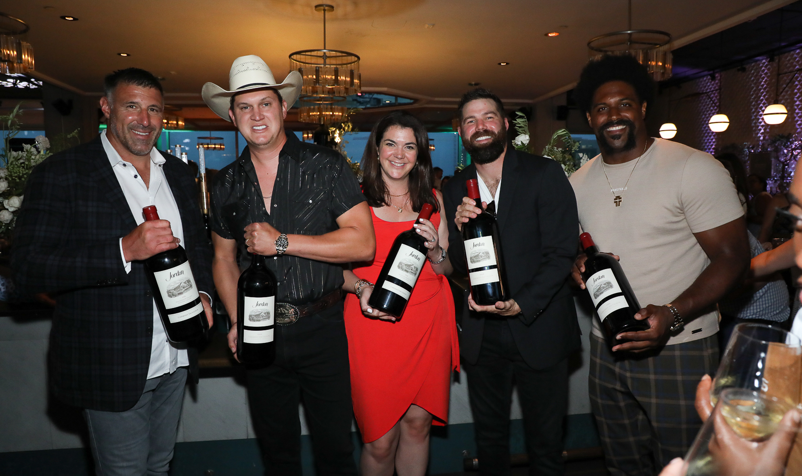 Big Bottles of Wine 5 persons carrying a big size bottle of Jordan Wine in a bar lounge