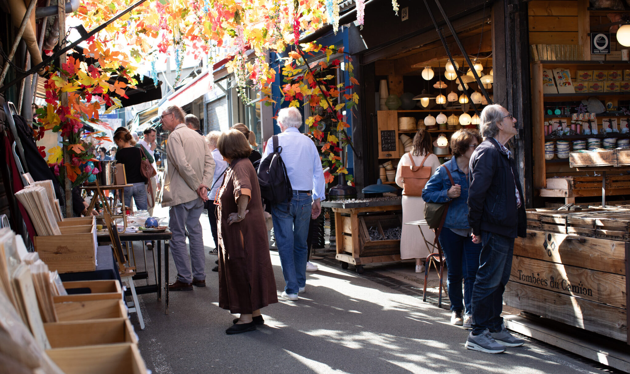 people walking around outdoor flea market in Paris
