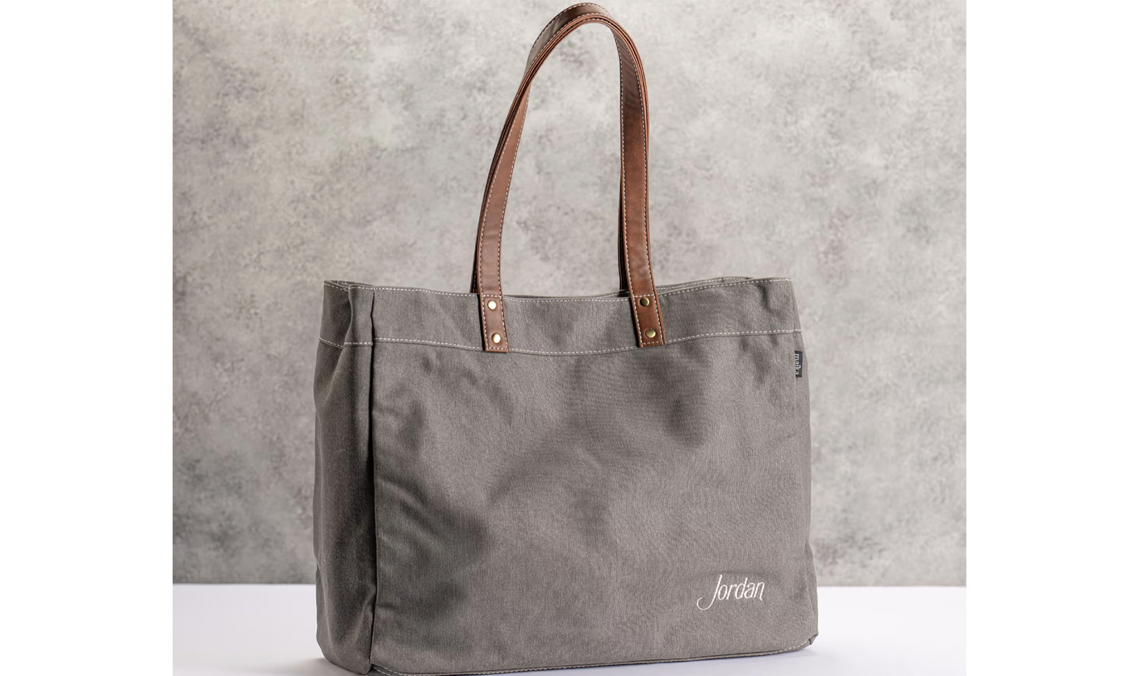 Gray tote bag with "Jordan" embroidery.
