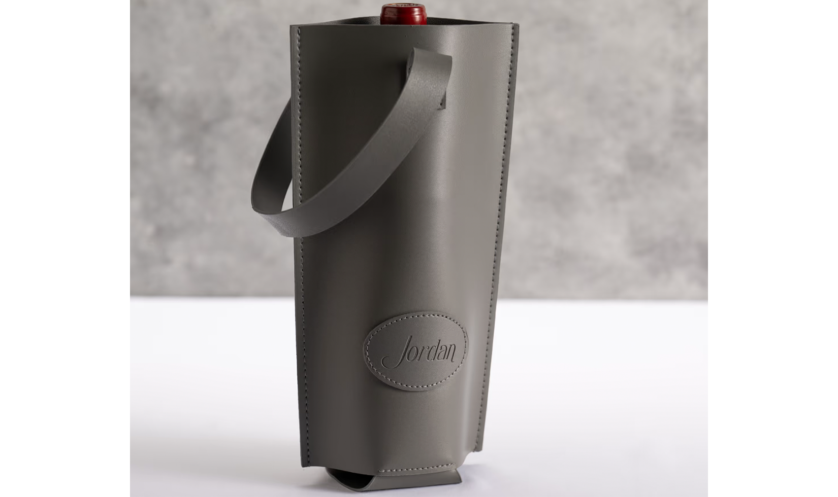 Gray Jordan-branded leather wine tote with a bottle inside.
