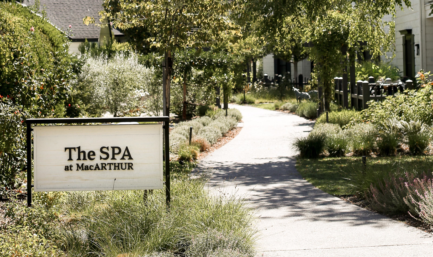 pathway through trees and resort with spa sign